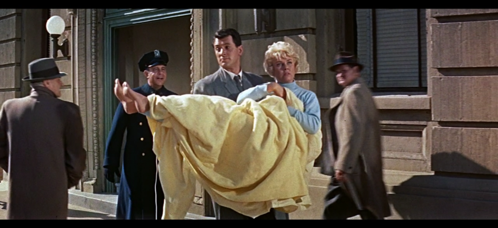 Fig. 4. Brad carries Jan across the street in her pajamas and electric blanket.