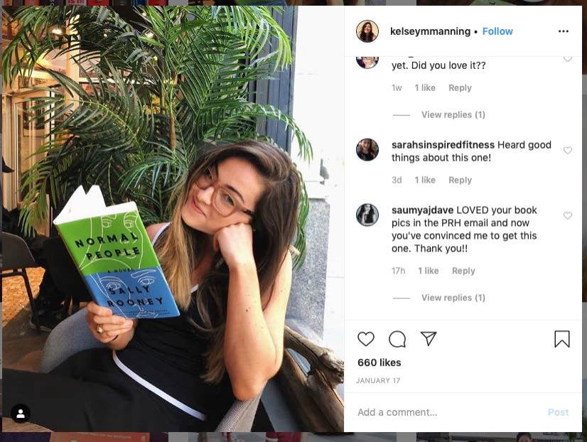 A young adult poses with a paper copy of "Normal People" in an Instagram post with hundreds of likes.