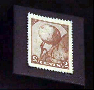 A postage stamp with a value of 2 cents bears an image of Sisyphus pushing a boulder up a hill.