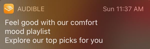 A banner phone notification from the Audible app that says "Feel good with our comfort mood playlist, explore our top picks for you."