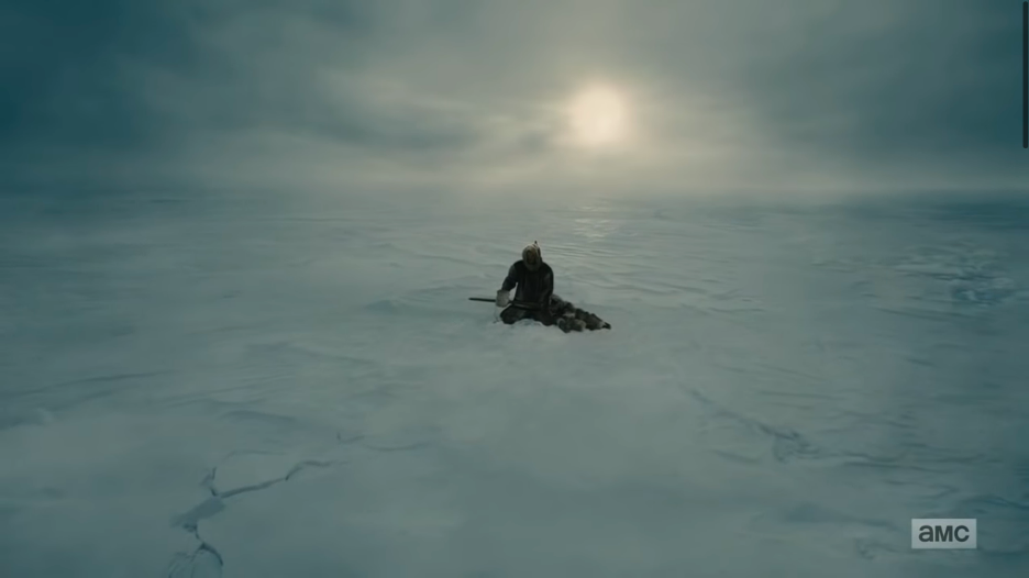 a television still of Jared Harris as Francis Crozier, wearing a hooded sealskin anorak and heavy gloves, holding a harpoon, sitting on his heels over a seal hole in the ice, while an Inuk child of about five or six naps at his feet in furs. This is a zoomed-out perspective of fig. 3, and the sea ice is here more visible around the figures.] 